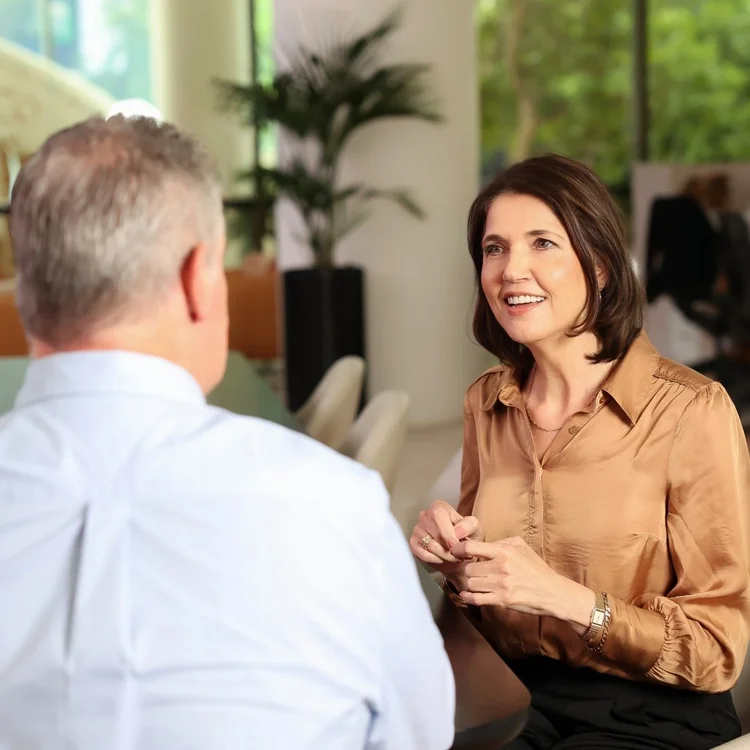 Annelie Peusschers in conversation, listening and smiling